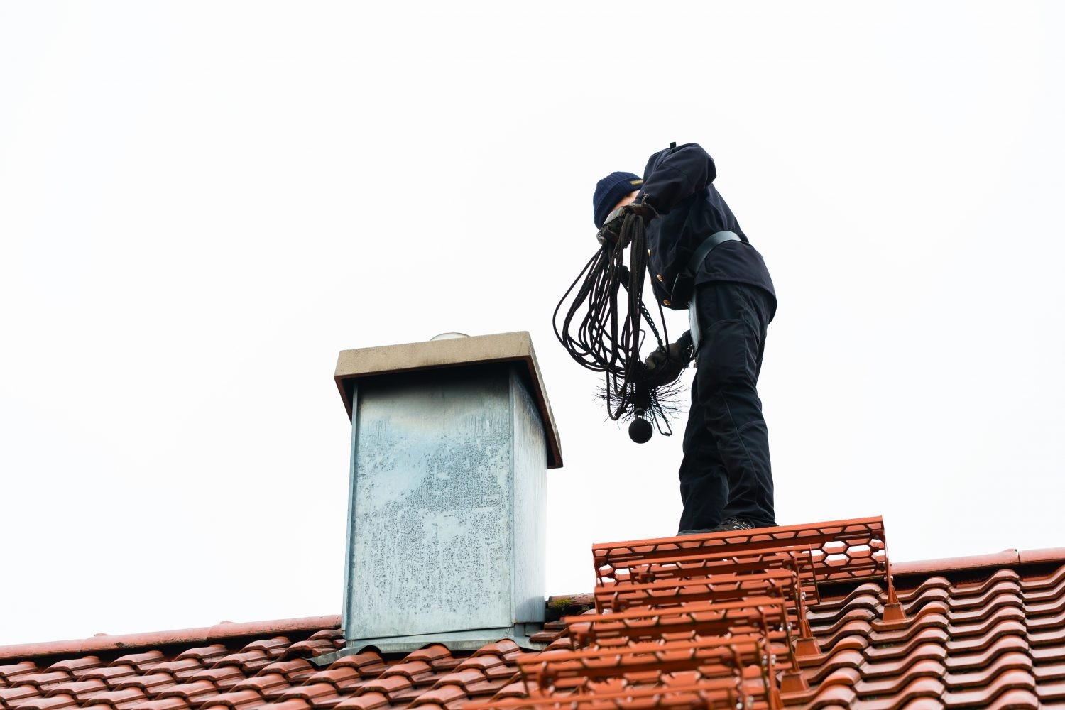 A chimney sweep during the chimney inspection